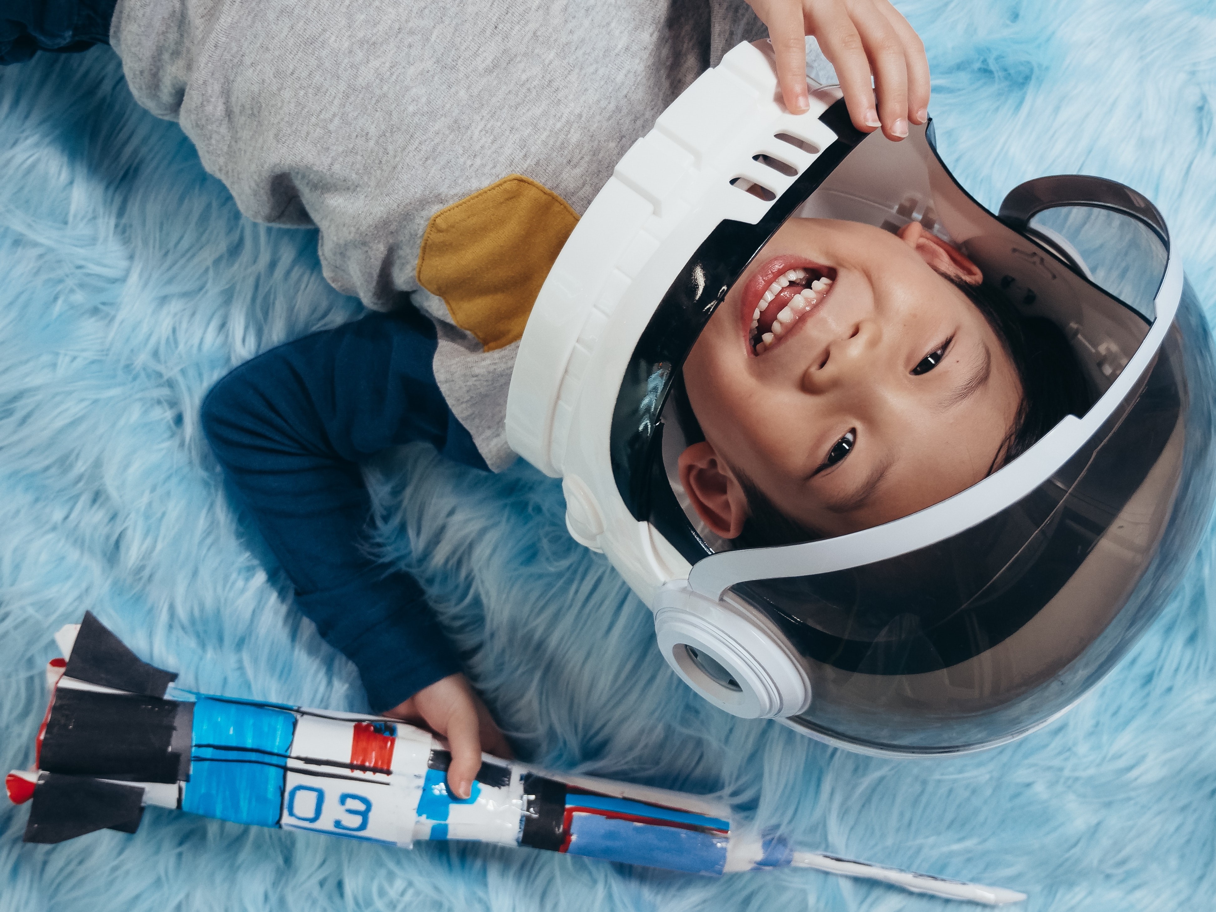 Boy role plays as an astronaut.